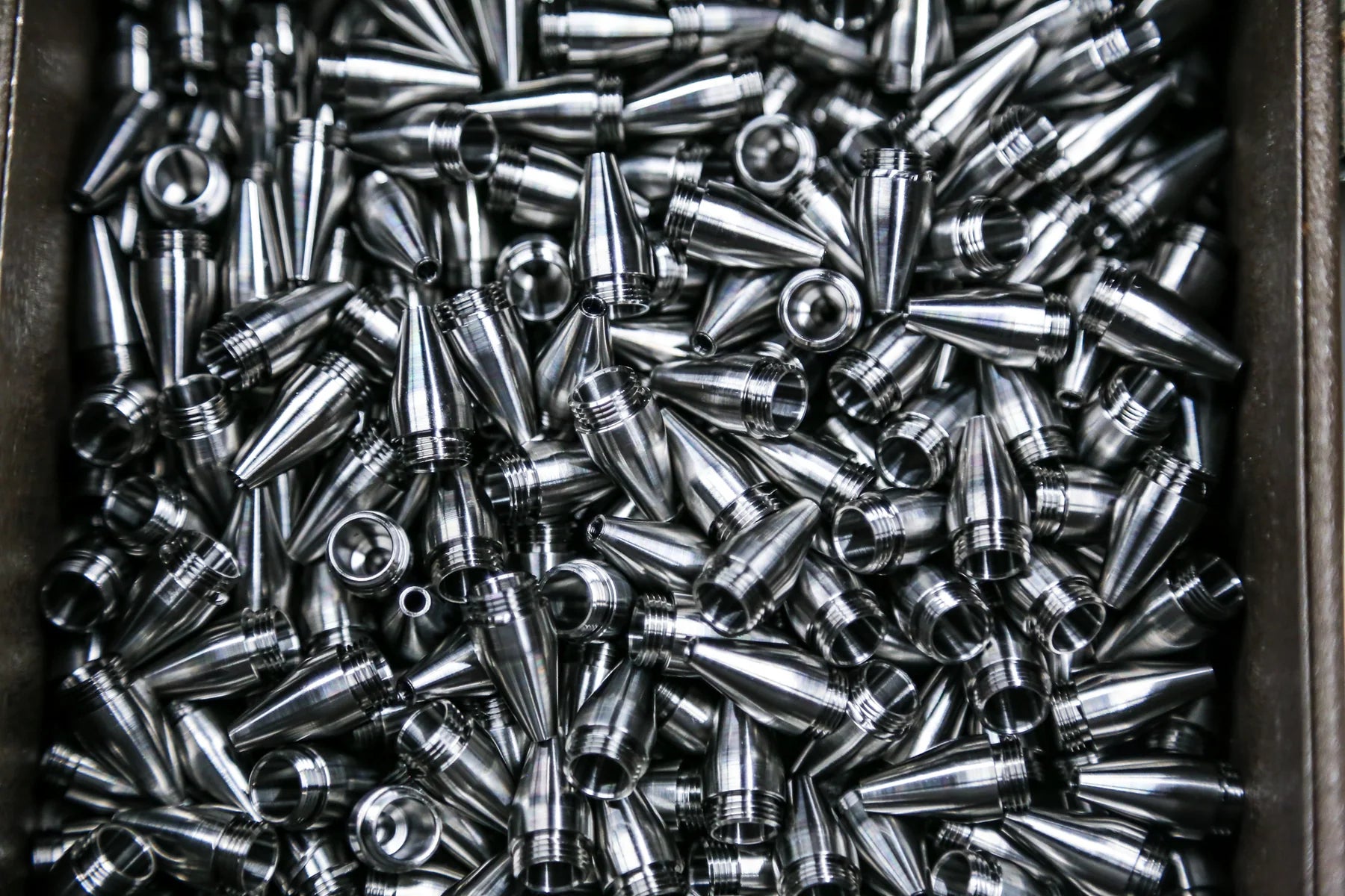 A production batch of small precision-machined metal components