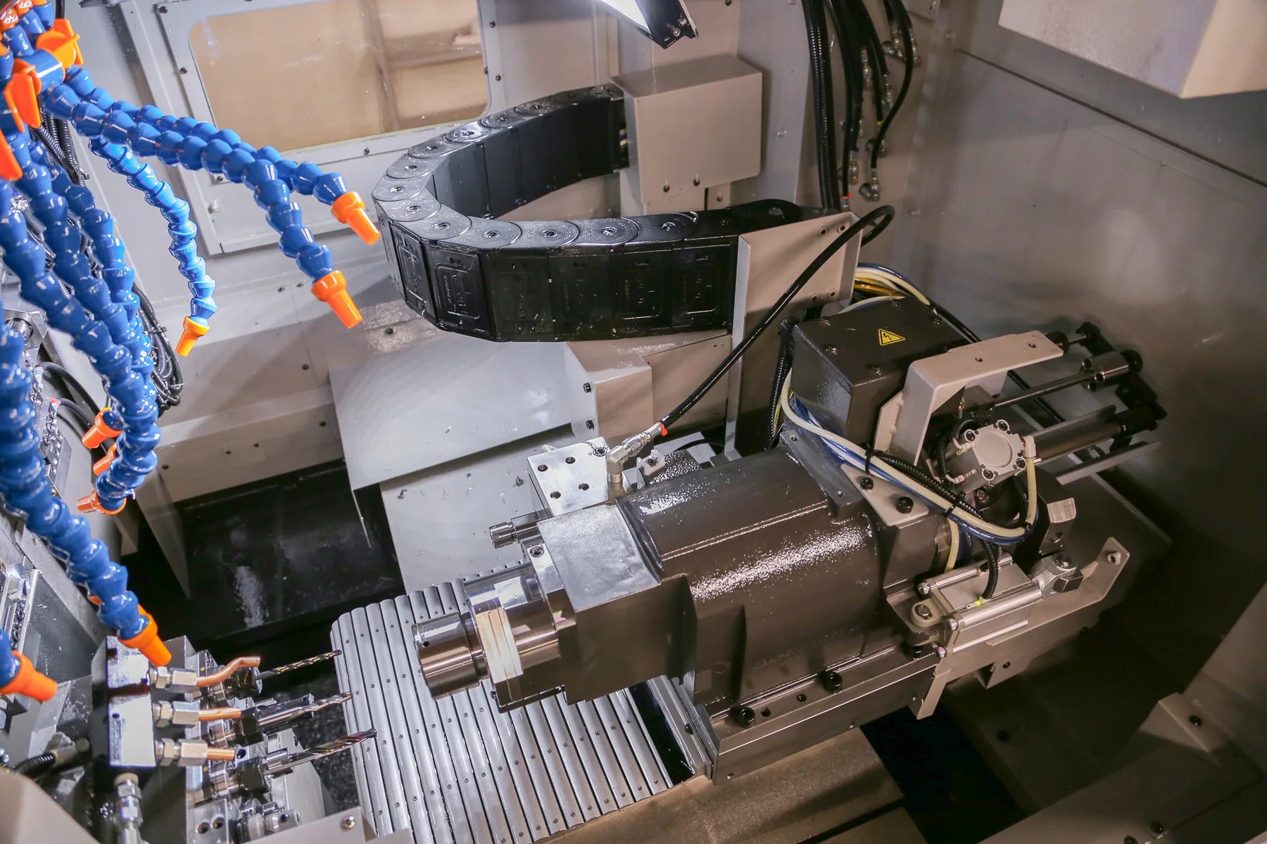 Sub-spindle, guideways, and tooling inside Veridune's Swiss CNC machine